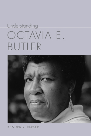 Inset photograph of a woman with a short afro, wearing dangle earrings on a pale purple background. Gray title above and author name below.