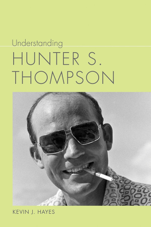 Inset photograph of a man wearing sunglasses and holding a cigarette in his teeth on a green background. Gray title above and author name below.
