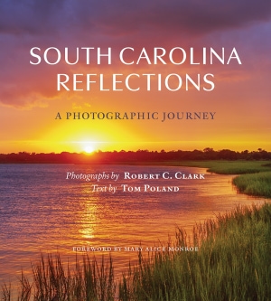 Colorful photograph of a marsh with the sun setting in the background. White title and purple subtitle above and white contributer names below.