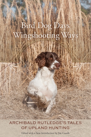 Brown and white dog sits on hay in front of hay stalks. White title at top, red subtitle and author name at bottom.