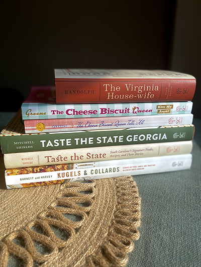 stack of books on table with linen tablecloth